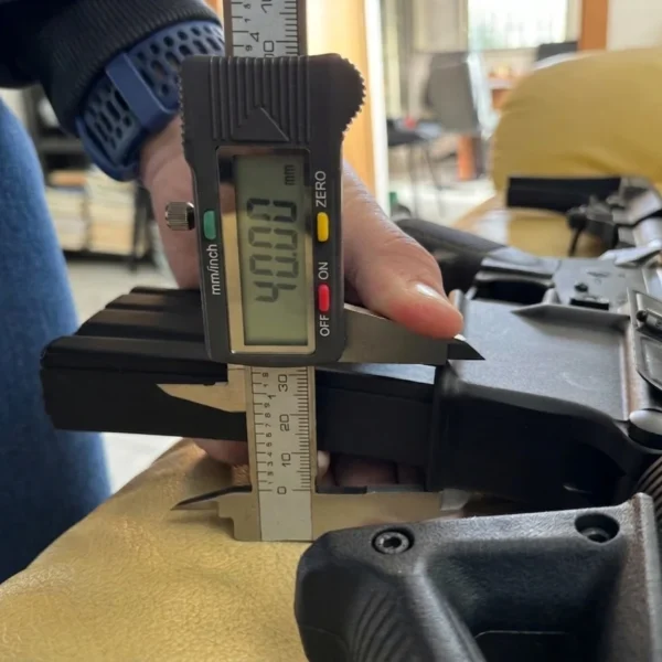 Medida con pie de rey sobre lower de fusil M4 para funnel de recarga